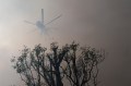 A helicopter seen flying through the smoke in California during a wildfire.