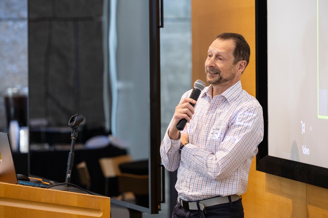 Tony Simon holding a microphone. 