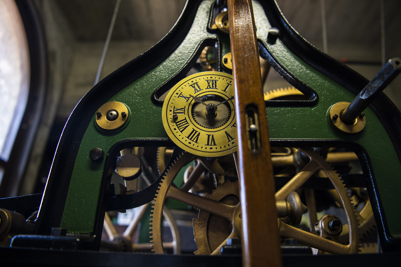 A small clock and gears inside of the Mills clock tower. 