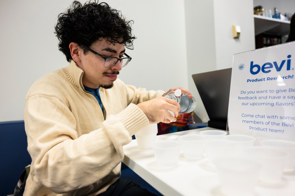 Matthew Chavez pouring a taste test sample of a bevi flavor.