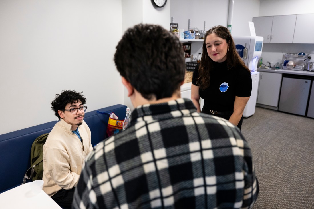 Matthew Chavez Cruz and two other people standing around a table near a Bevi machine.