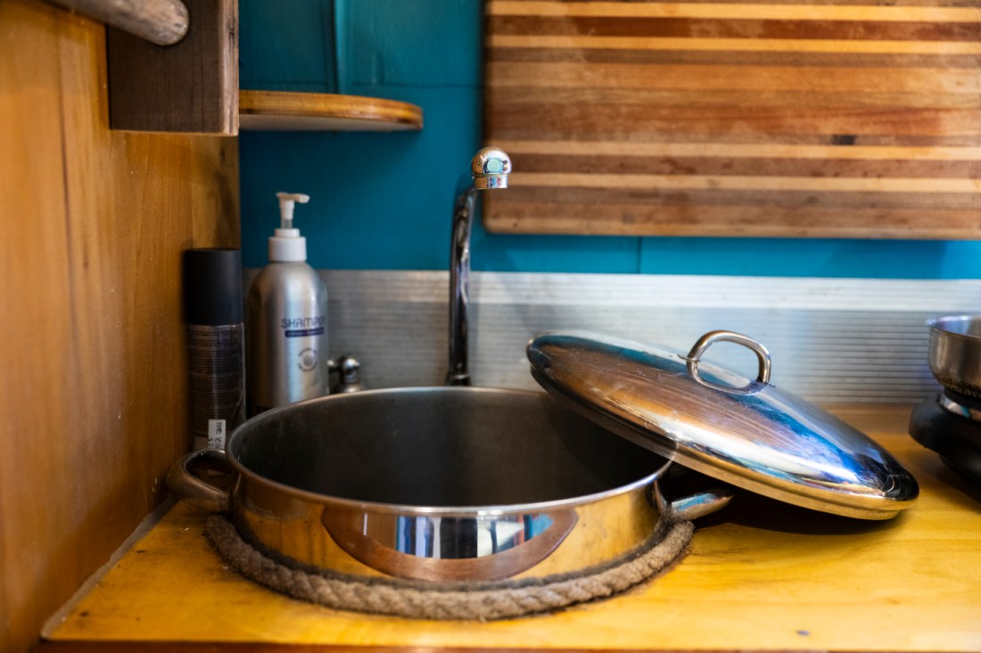 A sink made out of a pot in a U-Haul truck turned into a home.