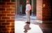 Portrait of Matt Bilotti standing outside of a brick building int he sunshine.