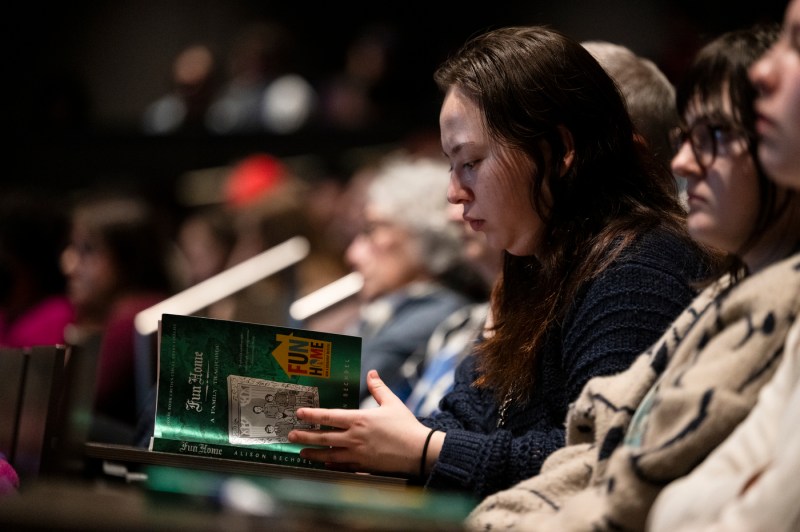 An audience member opening up a book.