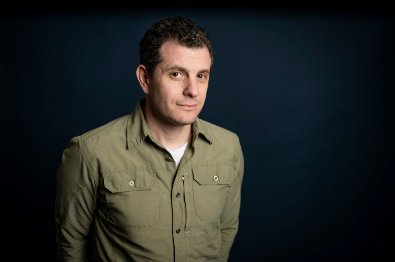 Dennis Staroselsky, a middle-age man with short brown hair, looks at the camera with a rumbled green collared shirt.