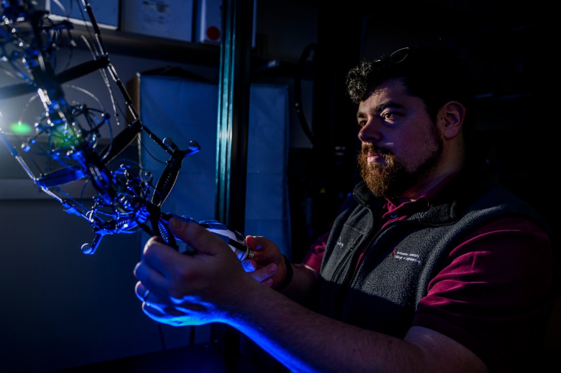 Jeffrey Lipton working on a robot.