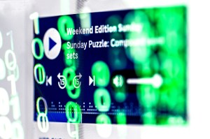 A screen paused on a video screen that has green rings reflecting on it.