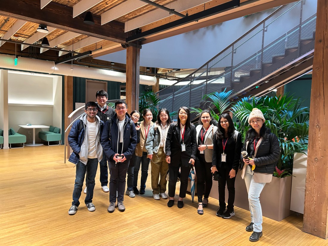 A group of people posing inside a Northeastern campus building.