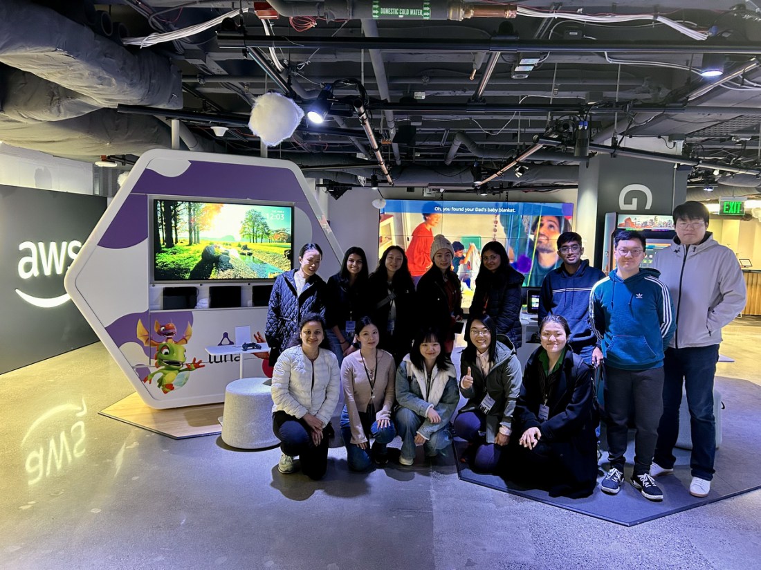 A group of people posing together at a conference.