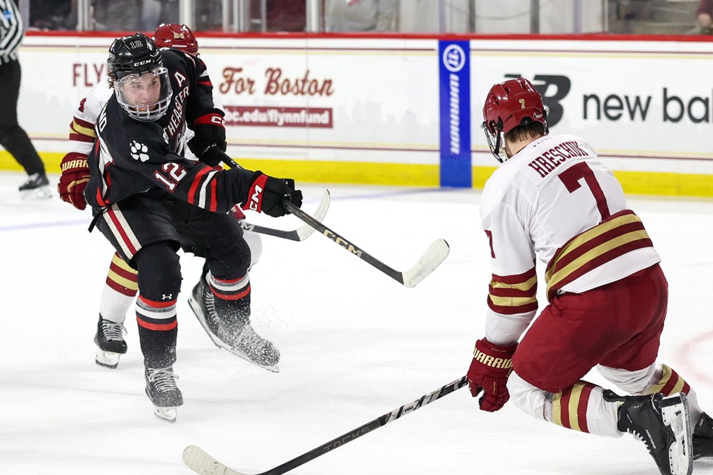 Northeastern and BC hockey players skating towards each other on the ice.