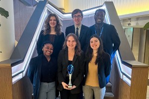 A group of students posing on a staircase.