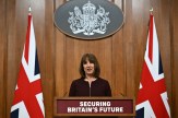 Rachel Reeves standing behind a podium next to two Union Jack Flags.
