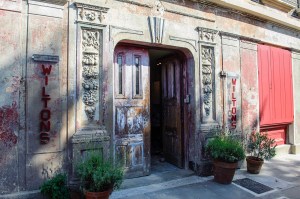 Entrance of Wilton’s Music Hall in London with rustic wooden doors and historic signage.