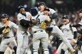 Yankees baseball players jumping on top of each other in celebration.