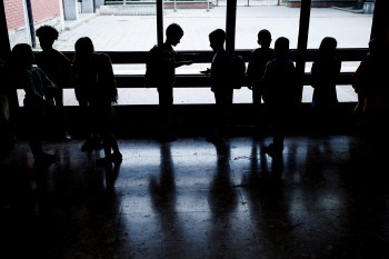 Silhouettes of groups of people in a school.