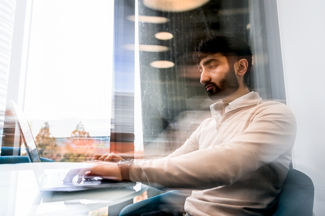 Saad Abdullah typing on a laptop.