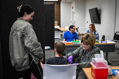 A medical staff member administering a measles vaccine.