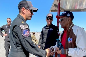 Daniel Keel shaking hands with another person wearing military clothing.