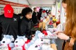 People standing inside of the Husky merch tent.