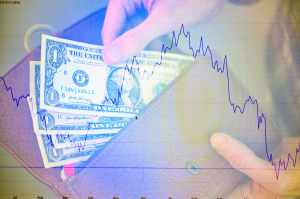 A financial concept image shows a hand pulling U.S. dollar bills out of an envelope overlaid with a declining stock market chart. The image has a purple/blue tinted overlay effect.