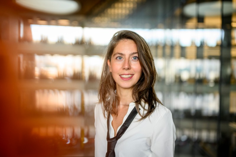 Cansu Canca, a woman with brown hair who directs the Responsible AI Practice at Northeastern, smiles against a sleek backdrop.