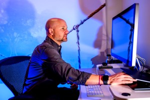 Matthew Goodwin sitting at a desk working on a computer.