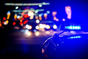 A police car with it's lights on at night.