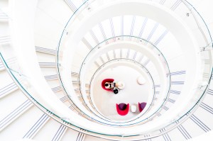 A person sits at the center of a circular architectural space viewed from above.