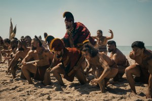 A scene from the show depicting armed men crouching on a beach.