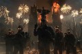 A group of heavily armed soldiers in a dark, surreal setting with glowing eyes, surrounded by fireworks and flames as a gothic building burns in the background.