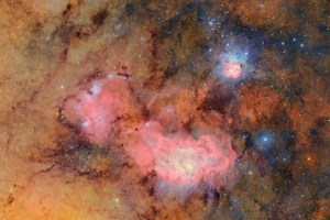 A vivid image of a colorful starfield showing deep space nebulae in red, pink, and blue hues, captured by the Vera C. Rubin Observatory.
