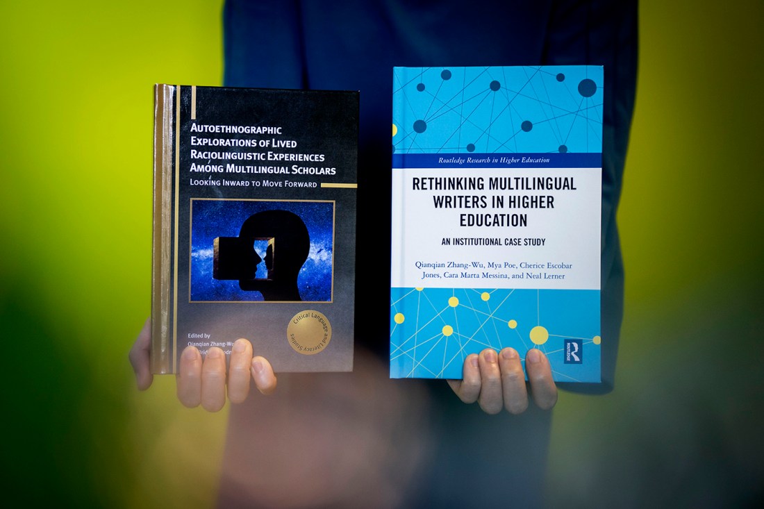 Qianqian Zhang-Wu, an assistant professor of English, holding up her book.