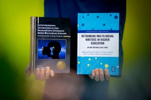 Qianqian Zhang-Wu, an assistant professor of English, holding up her book.