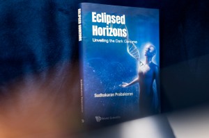 A book with a blue cover and the title 'Eclipsed Horizons' on it in white. There is also a humanoid figure with an enlarged DNA strand coming out of the chest.