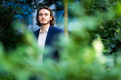 Portrait of Matthew Fleming wearing a button down shirt and blue blazer.