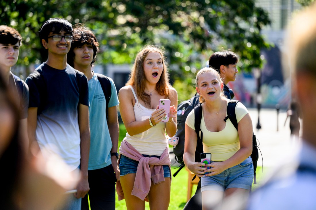 Excited students watch a model rocket launch.