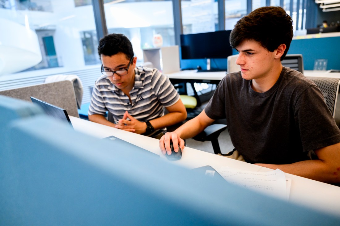 Students working on a laptop together.