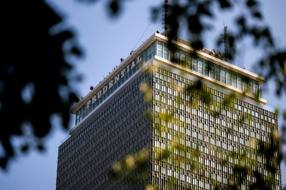 The Prudential Center building seen through the branches of a tree.