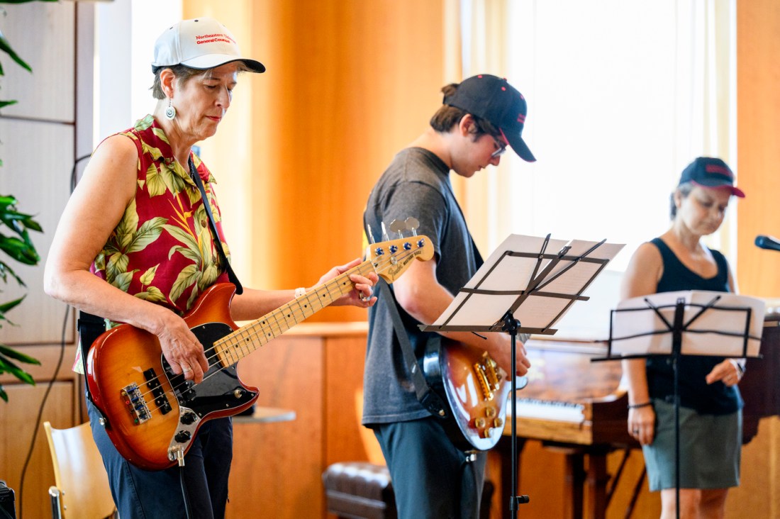 Band members on guitar and one vocalist performing