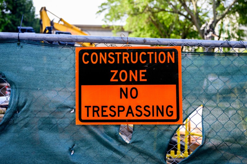 An orange construction sign that reads 'Construction Zone: No Trespassing."