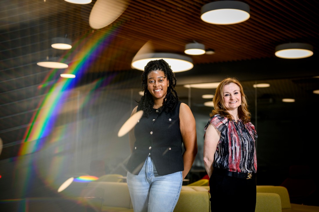 Portrait of Eniola Olaogun and Ioana Good standing side by side.
