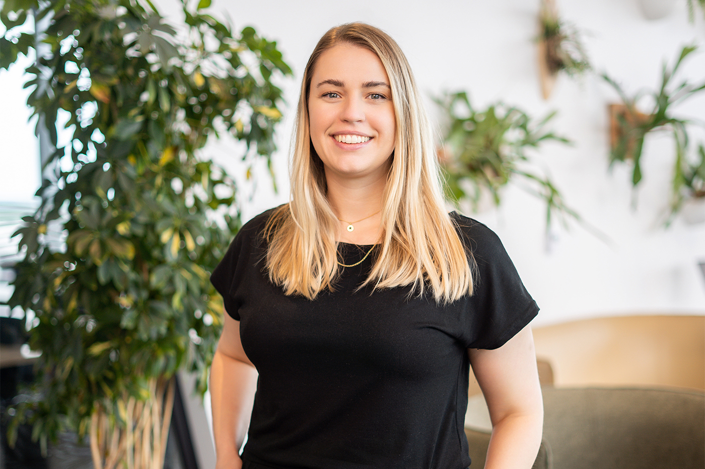 Annika Schoene, an assistant professor of public health and health sciences at Northeastern University, smiles, with a black shirt and long blonde hair.