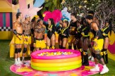 A screen capture from an episode of Love Island that shows the candidates standing in bathing suits around a inflatable pool full of balls.