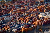 Rows of shipping containers seen in a port.