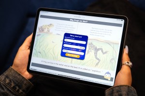 A person holding an iPad showing an AI literacy tool on a screen.