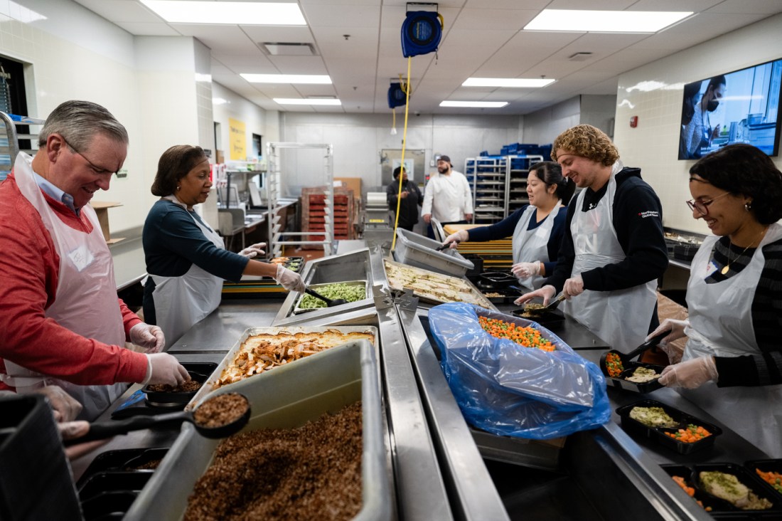 Members of Northeastern’s External Affairs team volunteer packing meals for individuals and their families with chronic illnesses at Community Servings.