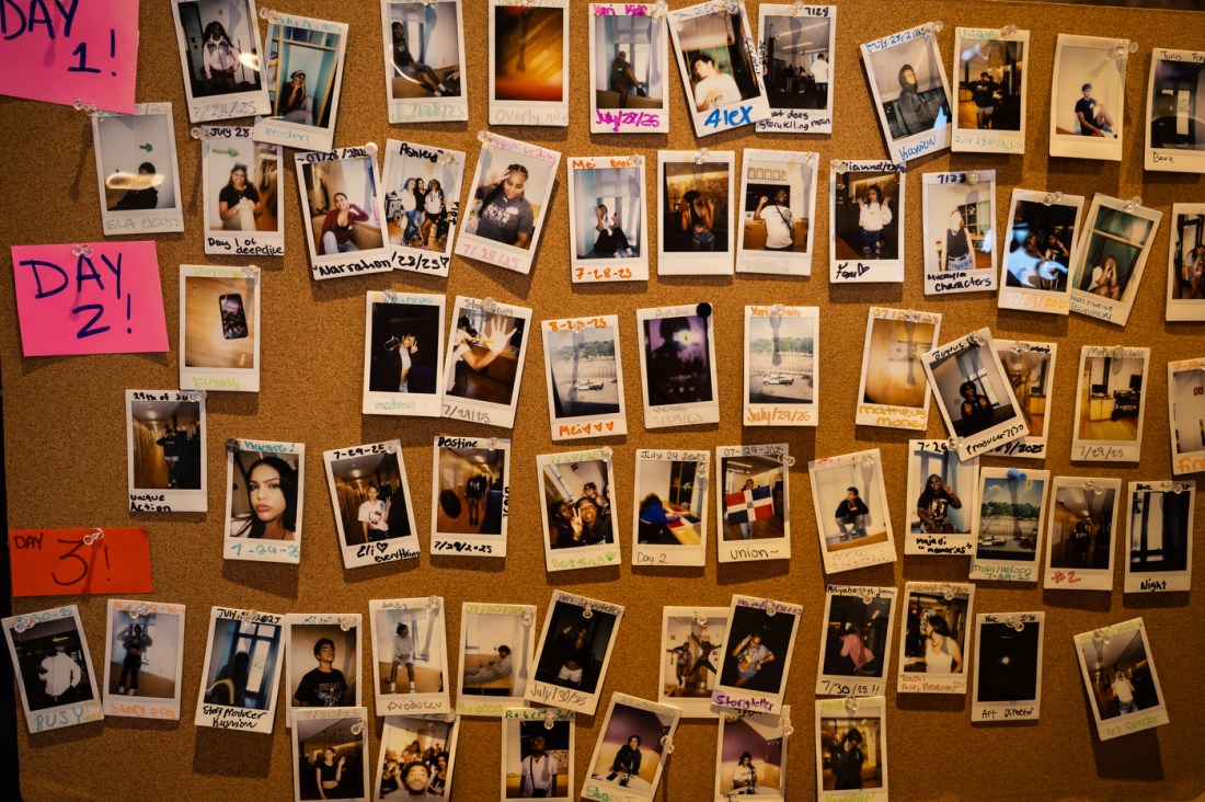 A corkboard filled with Polaroid photos grouped "Day 1", "Day 2", and "Day 3"