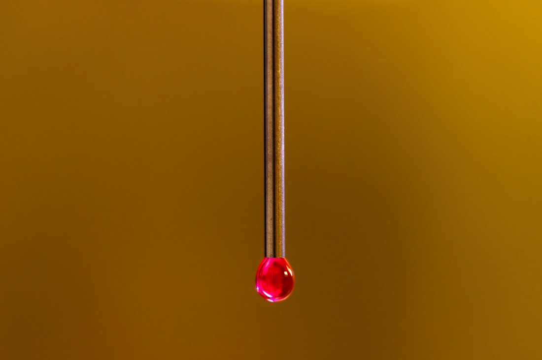 A surreal photo of a red water droplet.