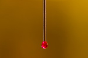 A surreal photo of a red water droplet.
