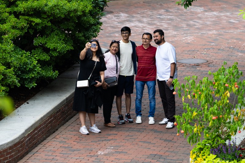 A family poses for a selfie on the Boston campus.